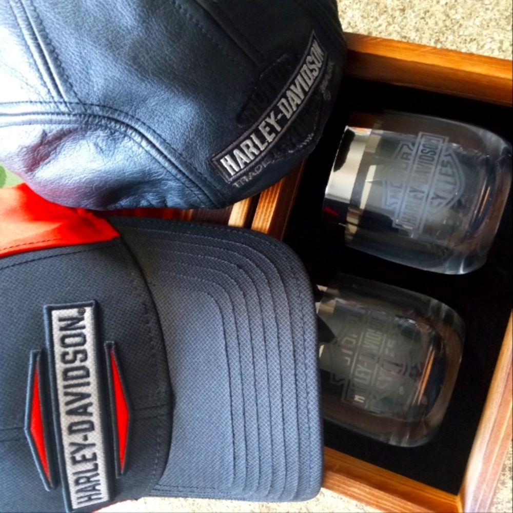 A vintage Harley-Davidson leather hat with two whiskey glasses and cap.